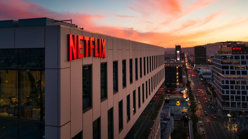 Netflix sign on a building at sunset.